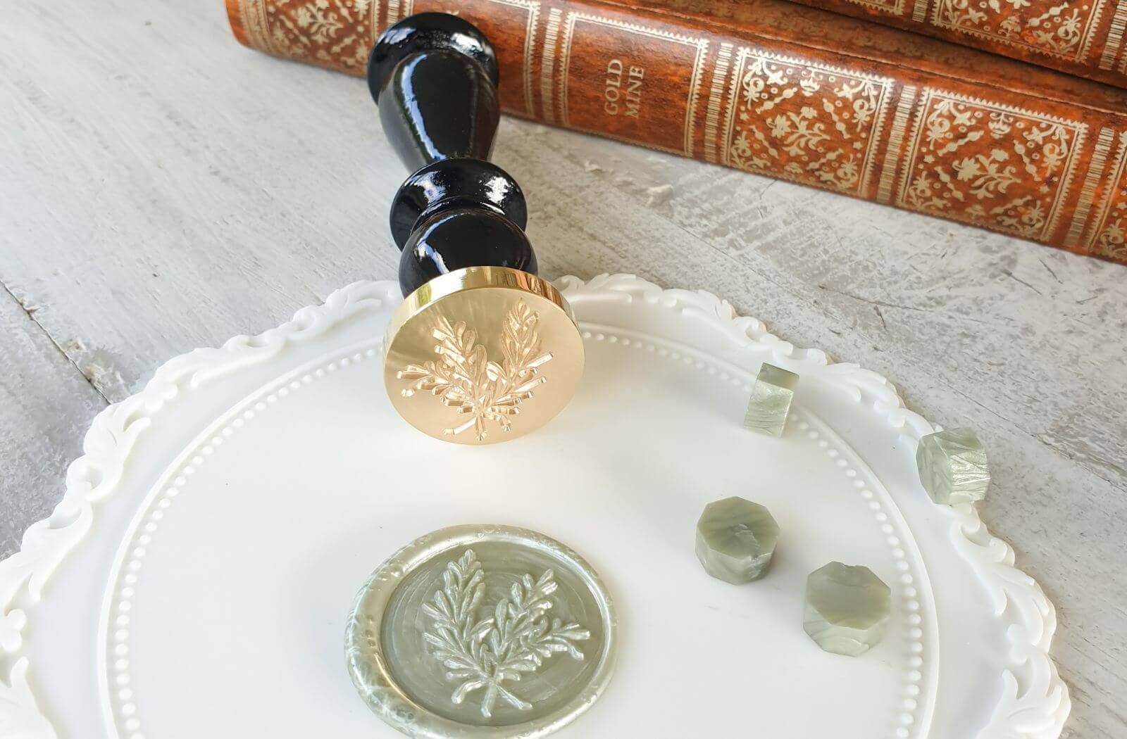 sage green wax seal with foliage design and rosemary wax seal stamp with sage green sealing wax