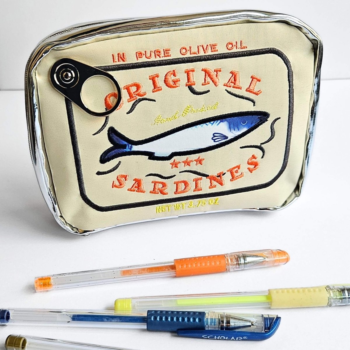 Pen pouch labeled 'Original Sardines' with pens on a white background