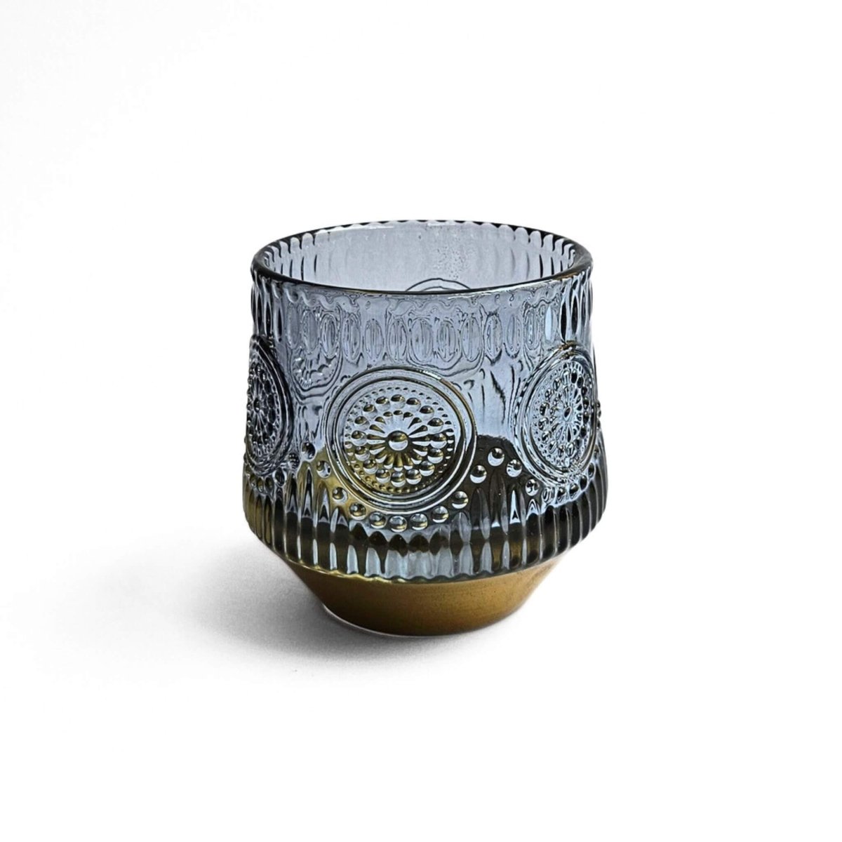 Decorative blue glass pen holder with intricate patterns on a white background