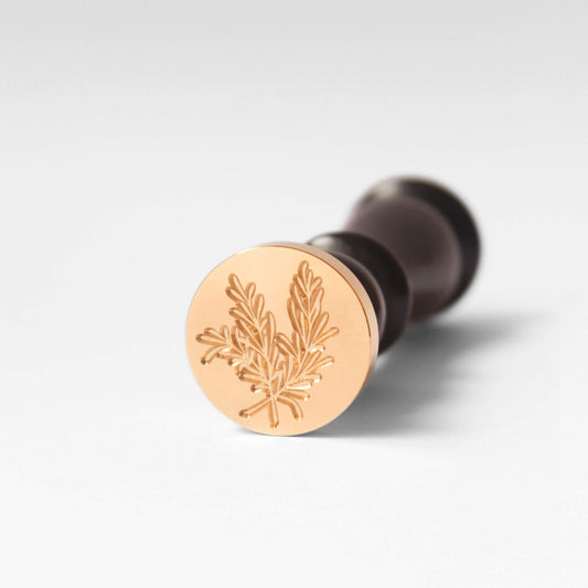 brass wax seal head engraved with rosemary leaf motif and black wooden wax seal handle in vintage style