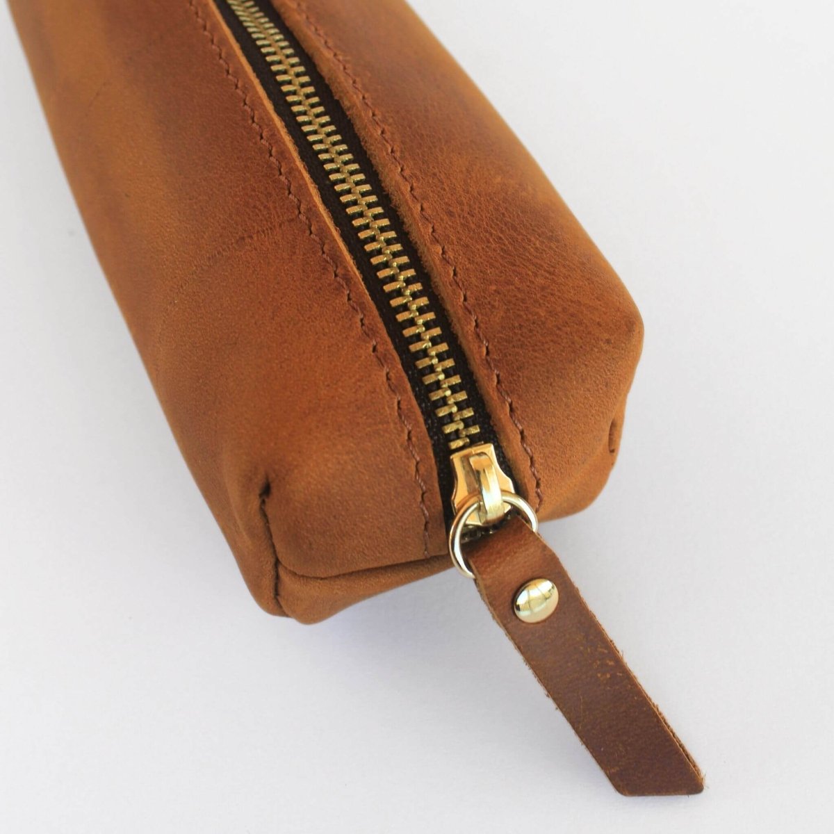 close up of distressed leather pencil case in chestnut brown