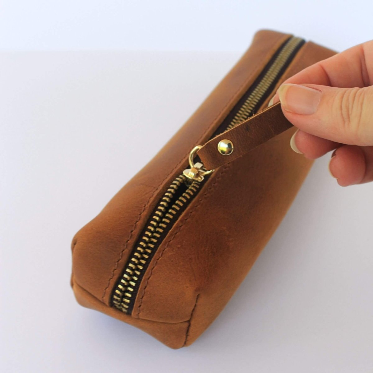 hand opening zip on tan leather pencil case