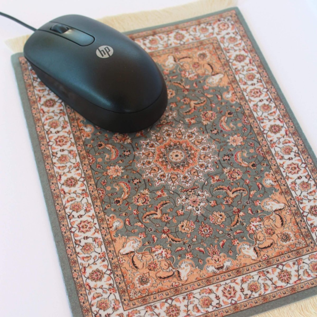 computer mouse on mouse pad that looks like a carpet rug